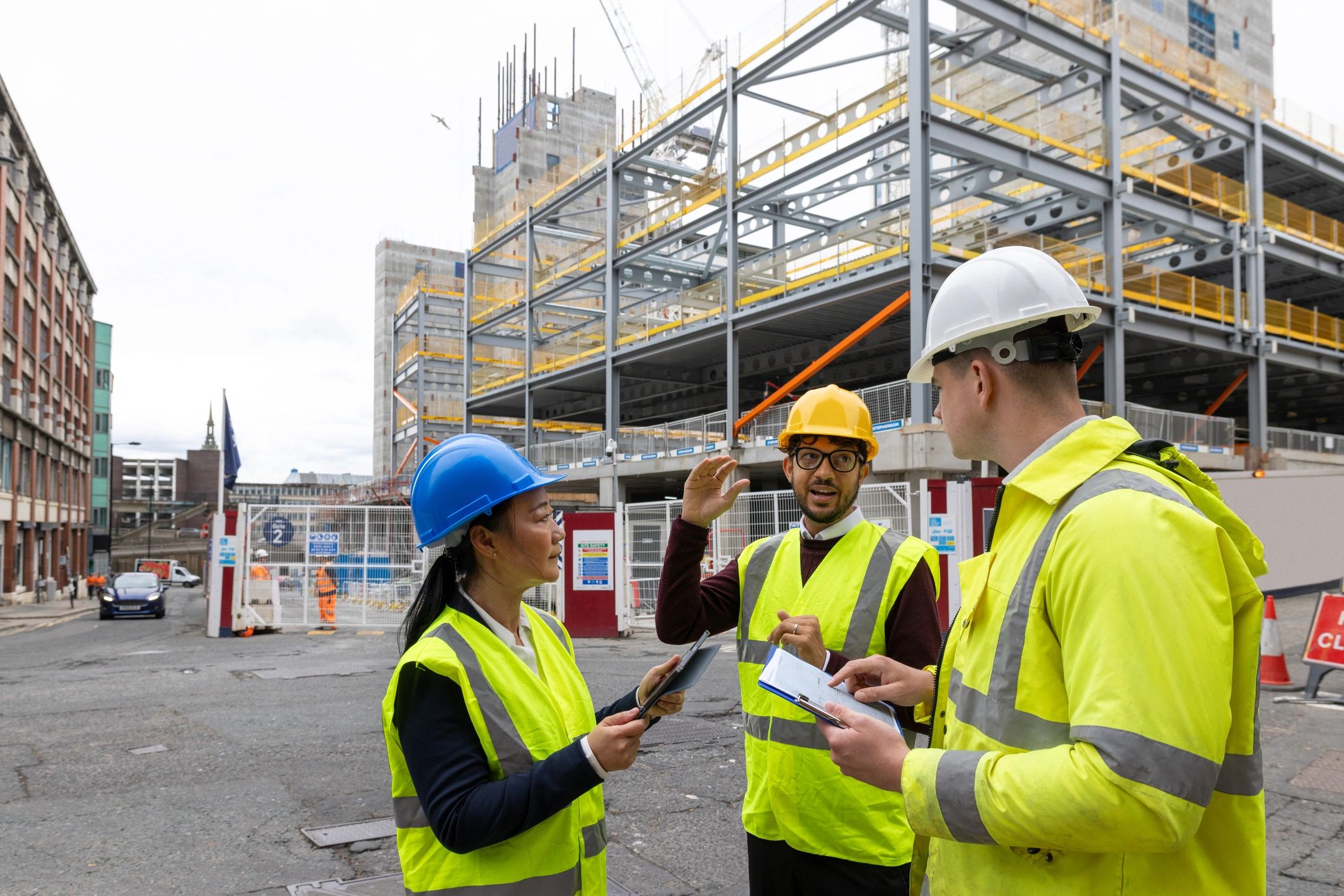 Construction professionals reviewing plans outdoors